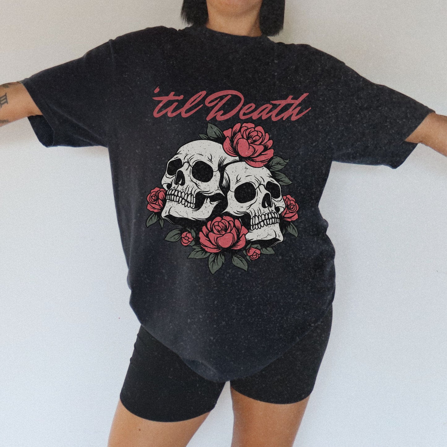Graphic tee featuring a bold skull and roses design with vintage-inspired details. Perfect for fans of retro skeleton shirts, romantic gothic skull tees, or punk skull rose graphics. A unique aesthetic tattoo skull tee for edgy and dark romance lovers.