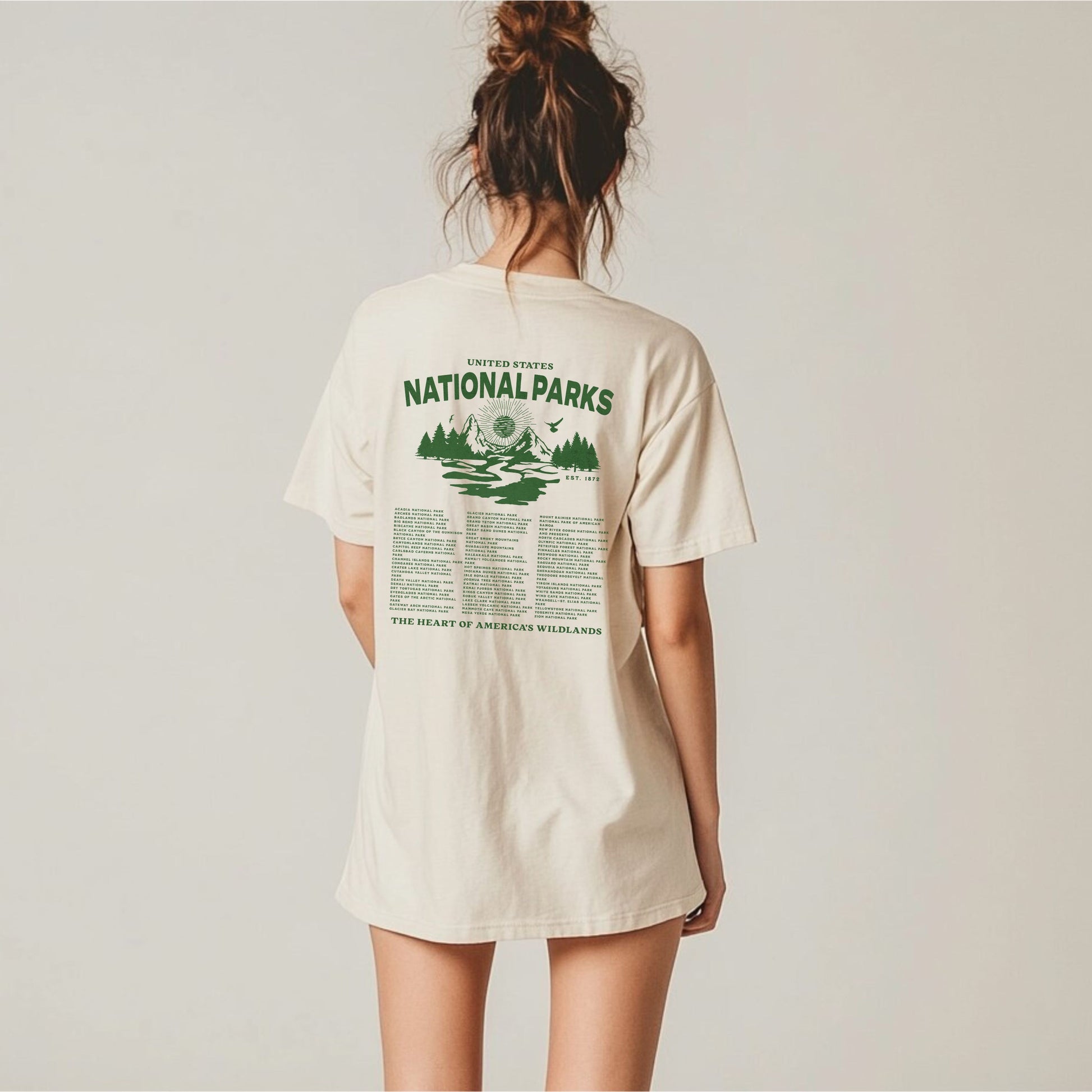 Person wearing a cream t-shirt with 'National Parks' text on the back against a plain background