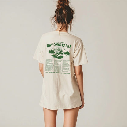 Person wearing a cream t-shirt with 'National Parks' text on the back against a plain background