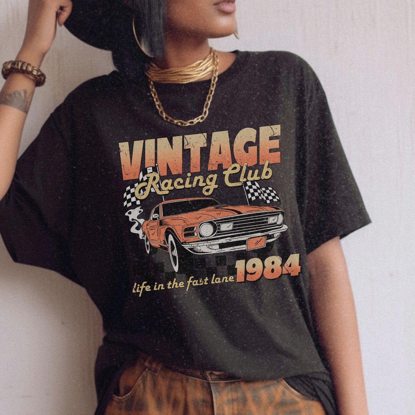 Retro racing T-shirt featuring a bold 1984 vintage design with distressed car graphics. Perfect nostalgic car shirt for muscle car lovers, featuring checkered flag details. Ideal for fans of old school racing and fast lane graphic tees.