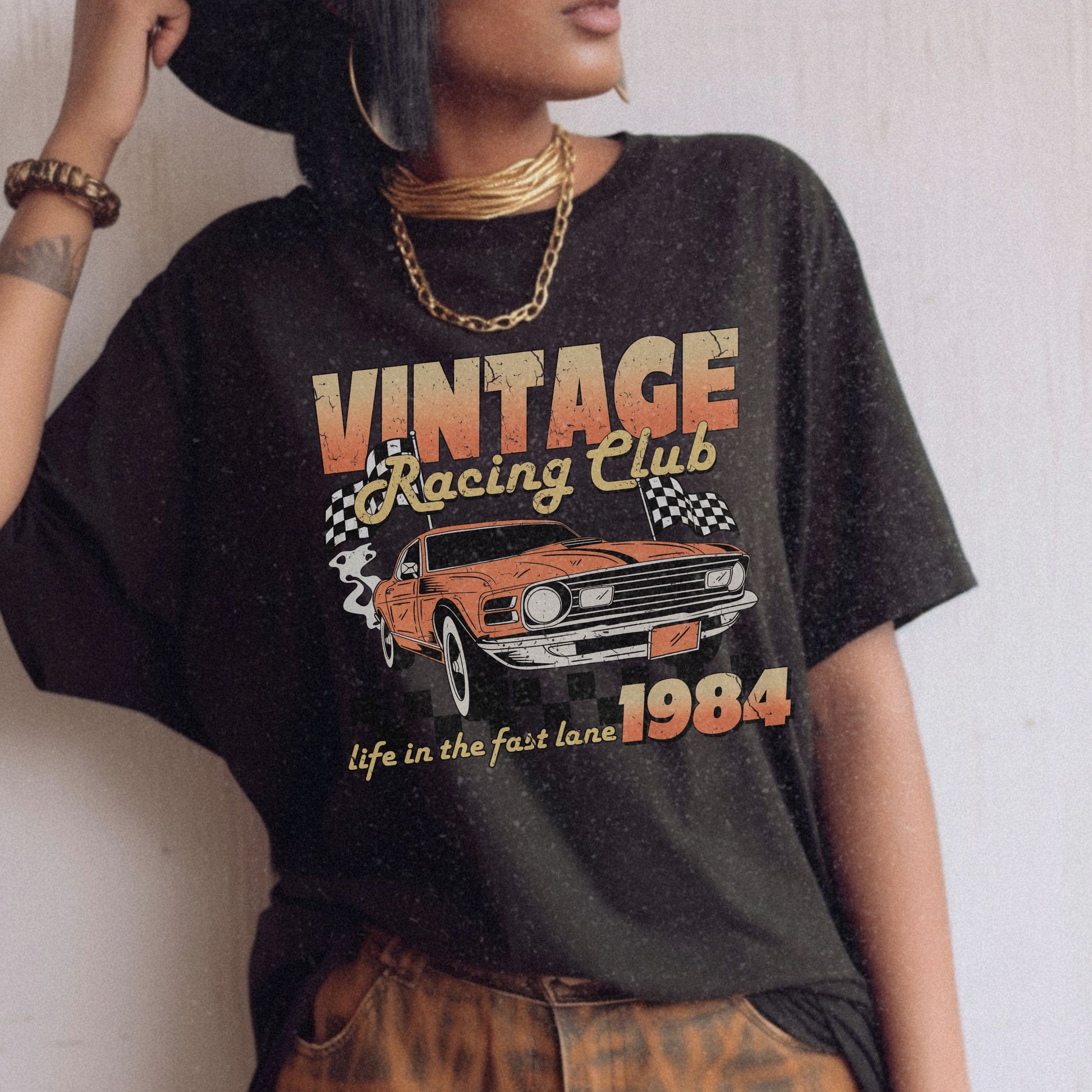 Retro racing T-shirt featuring a bold 1984 vintage design with distressed car graphics. Perfect nostalgic car shirt for muscle car lovers, featuring checkered flag details. Ideal for fans of old school racing and fast lane graphic tees.