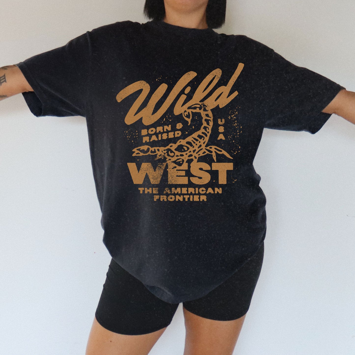 Vintage western shirt with a scorpion graphic and distressed details. Retro cowboy t-shirt inspired by the American West. Rodeo graphic t-shirt with a rustic frontier style. Wild West graphic tee with a bold design for a rugged, adventurous look.