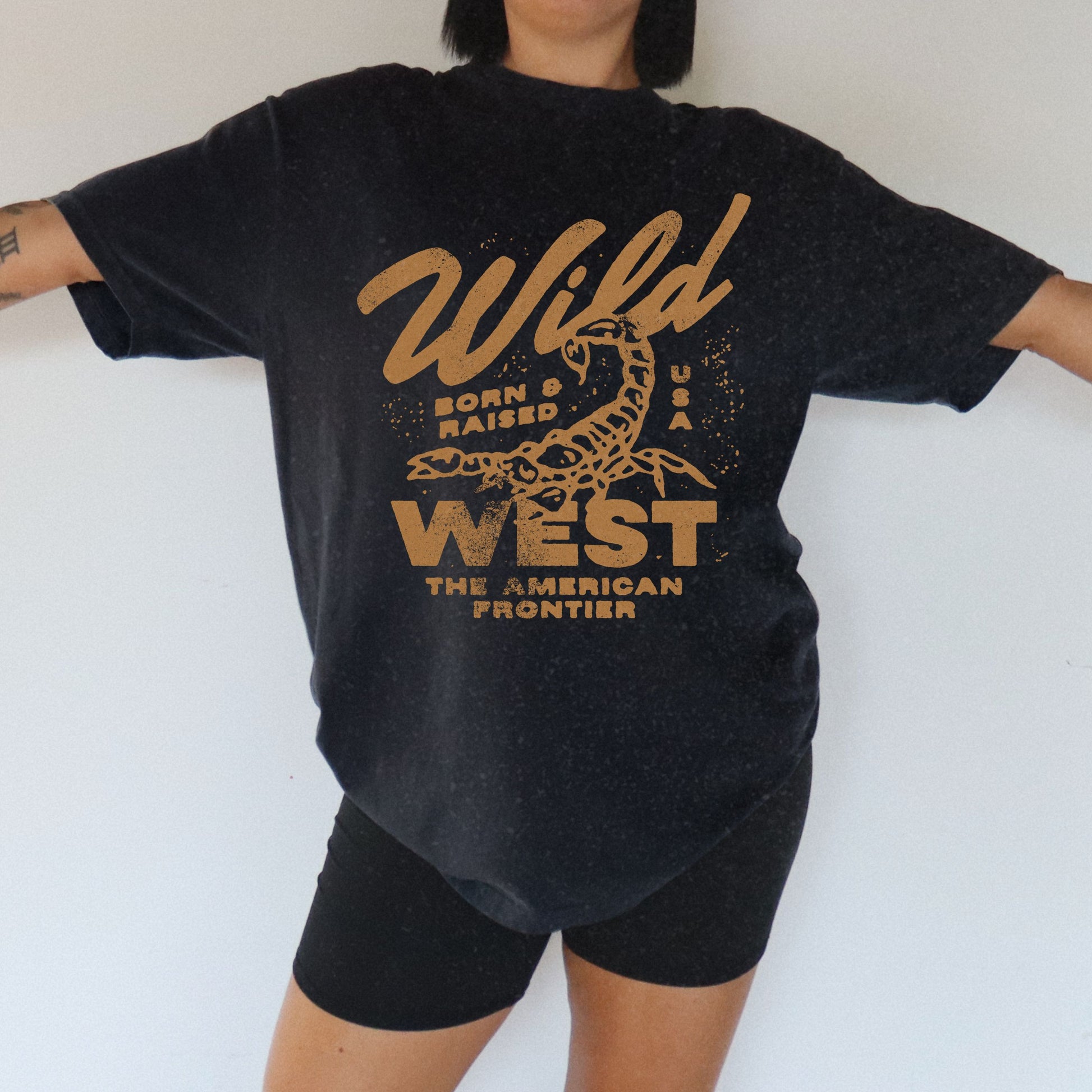 Vintage western shirt with a scorpion graphic and distressed details. Retro cowboy t-shirt inspired by the American West. Rodeo graphic t-shirt with a rustic frontier style. Wild West graphic tee with a bold design for a rugged, adventurous look.