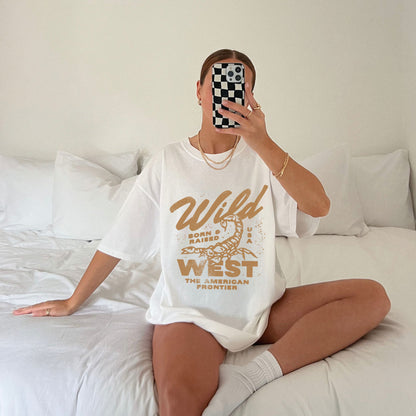 Vintage western shirt with a scorpion graphic and distressed details. Retro cowboy t-shirt inspired by the American West. Rodeo graphic t-shirt with a rustic frontier style. Wild West graphic tee with a bold design for a rugged, adventurous look.