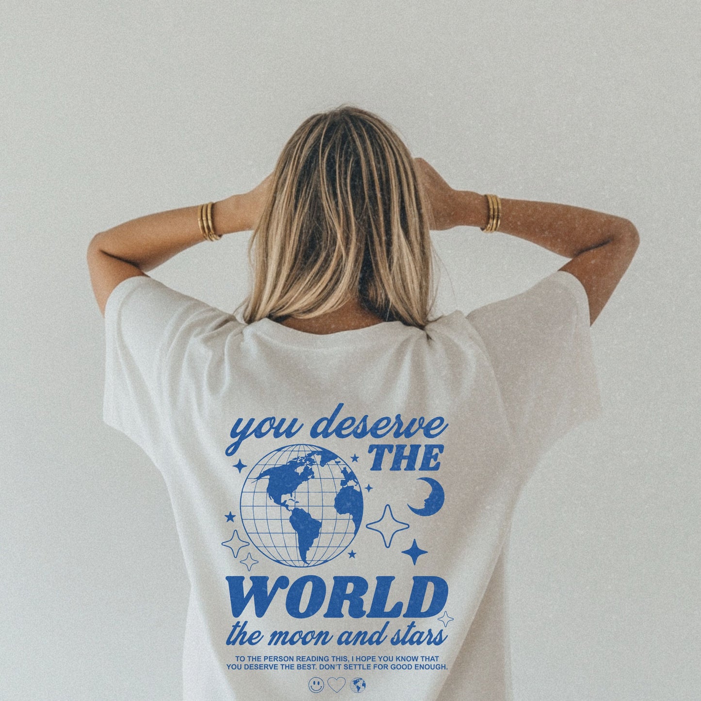 Motivational graphic t-shirt with a celestial design featuring stars, moon, and globe. Includes the inspiring phrase 'you deserve the world.' A trendy and stylish vintage-inspired tee for casual wear, perfect for spreading positivity and empowerment.