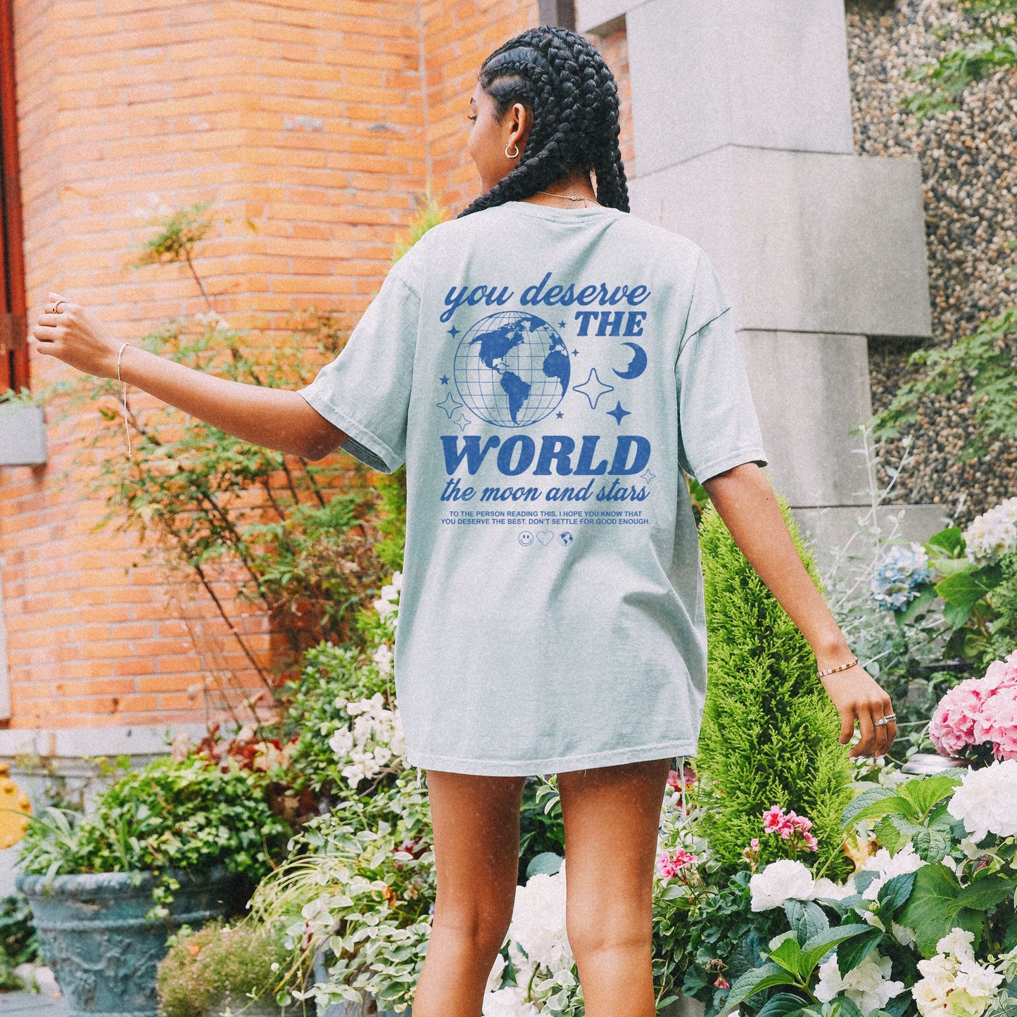 Motivational graphic t-shirt with a celestial design featuring stars, moon, and globe. Includes the inspiring phrase 'you deserve the world.' A trendy and stylish vintage-inspired tee for casual wear, perfect for spreading positivity and empowerment.